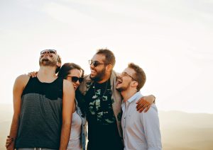 group of friends laughing together showing support to eachother